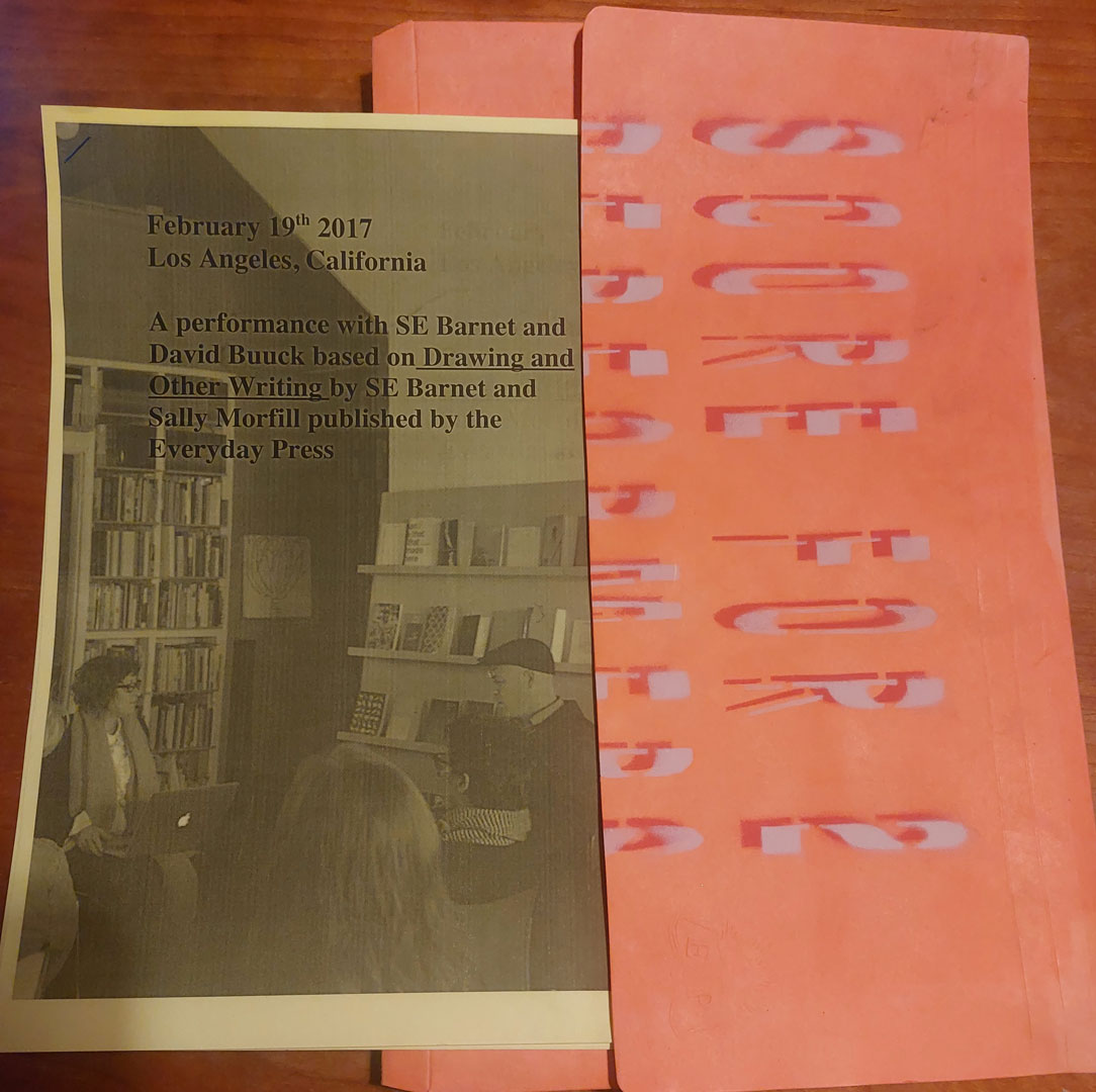 photo of a b/w flyer with grey background, with an orange and red cover with the title